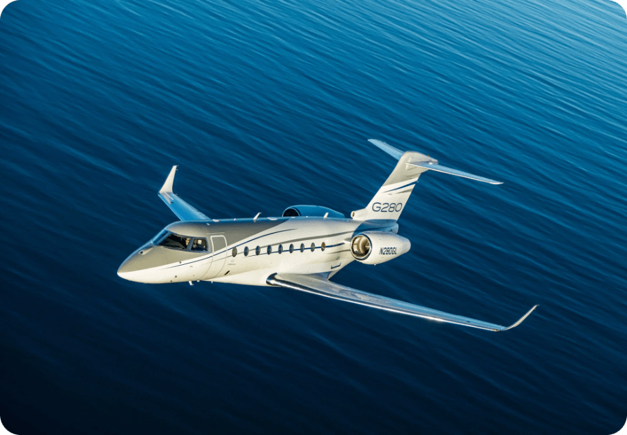 Gulfstream G280 private jet flying over ocean